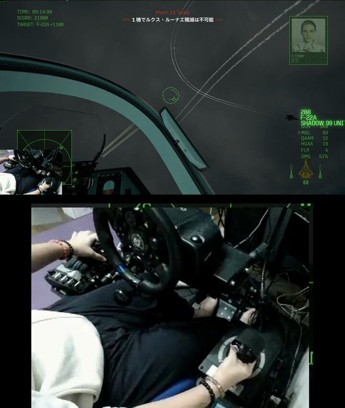 In-game cockpit view over a night sky, with the creator's HOTAS rig filmed below