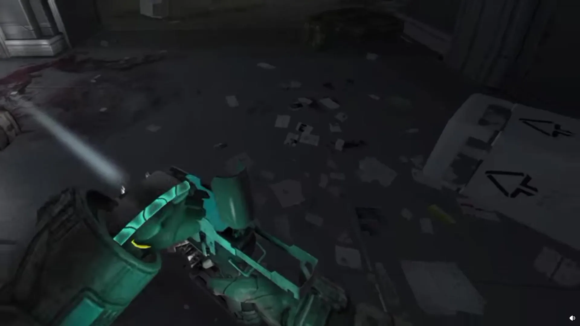 First-person view of a teal plasma cutter held open in a tracked hand, flashlight on, over a floor littered with paper