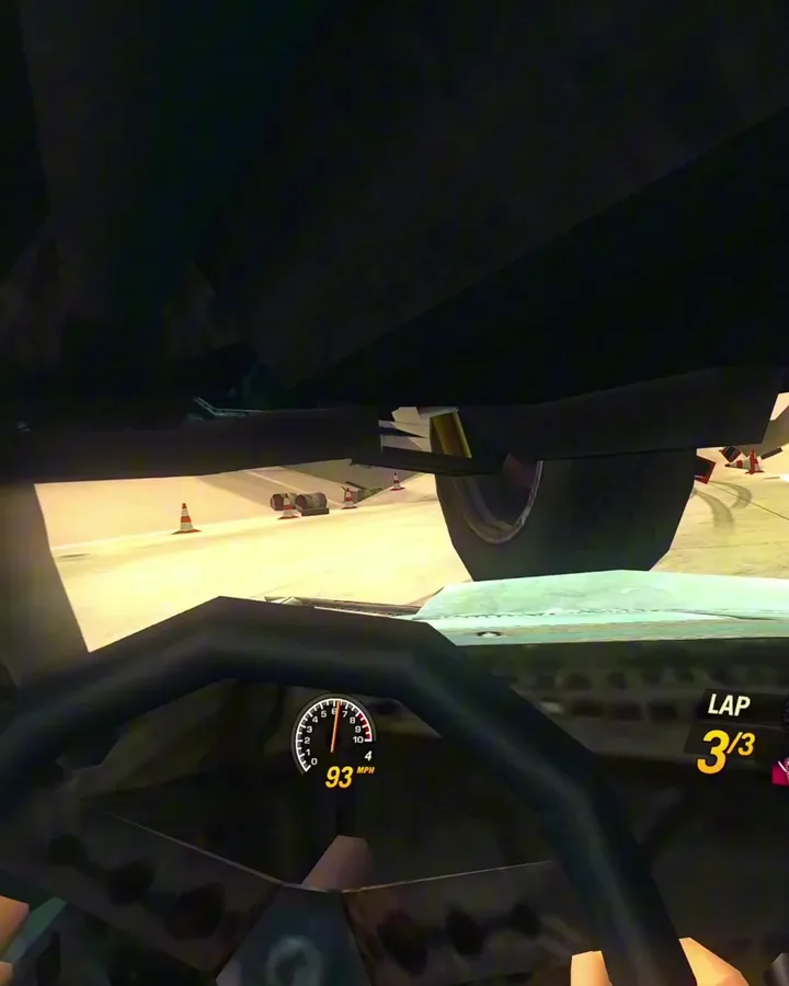 FlatOut 2 VR cockpit view as another car flies directly overhead, its underside and a tire filling the top of the windscreen, speedometer at 93 mph