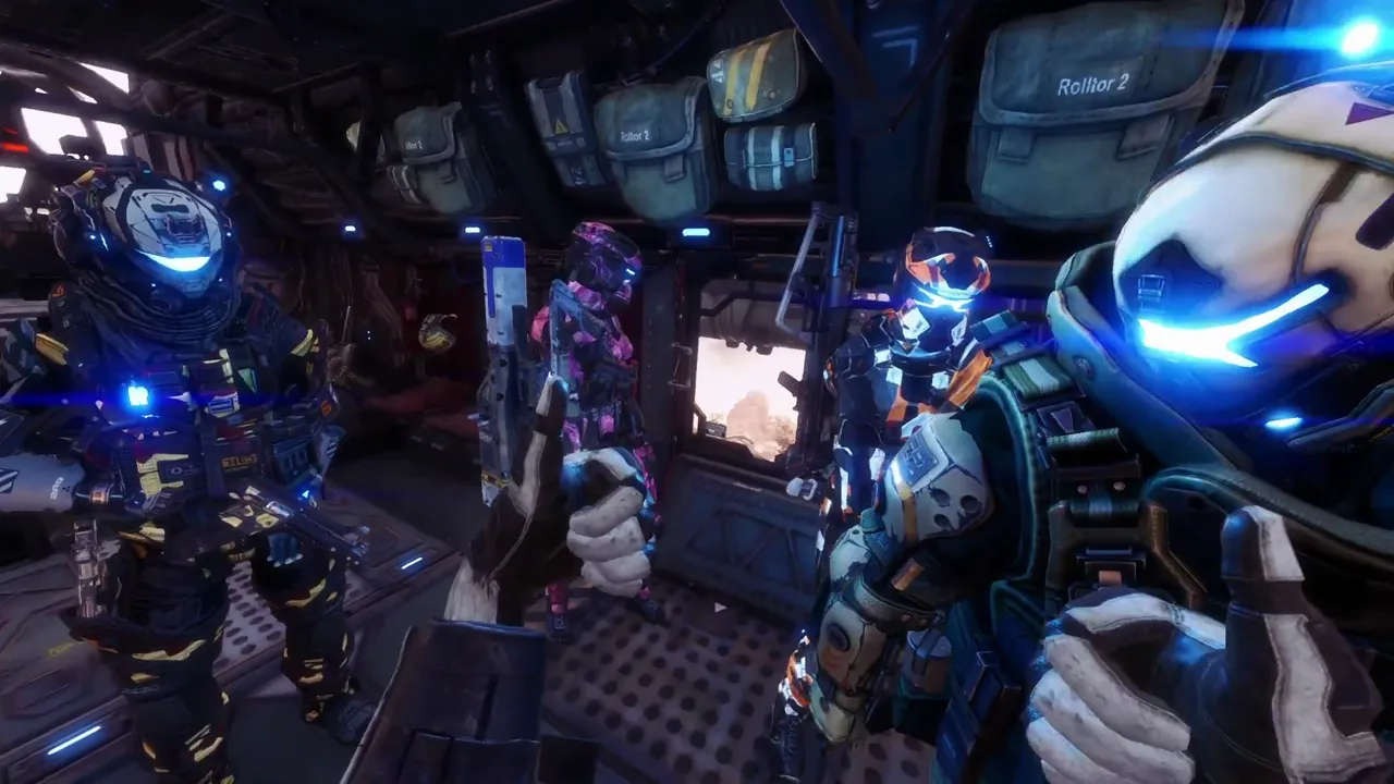 First-person view inside a dark dropship, with three helmeted pilots giving thumbs-up gestures with gloved hands